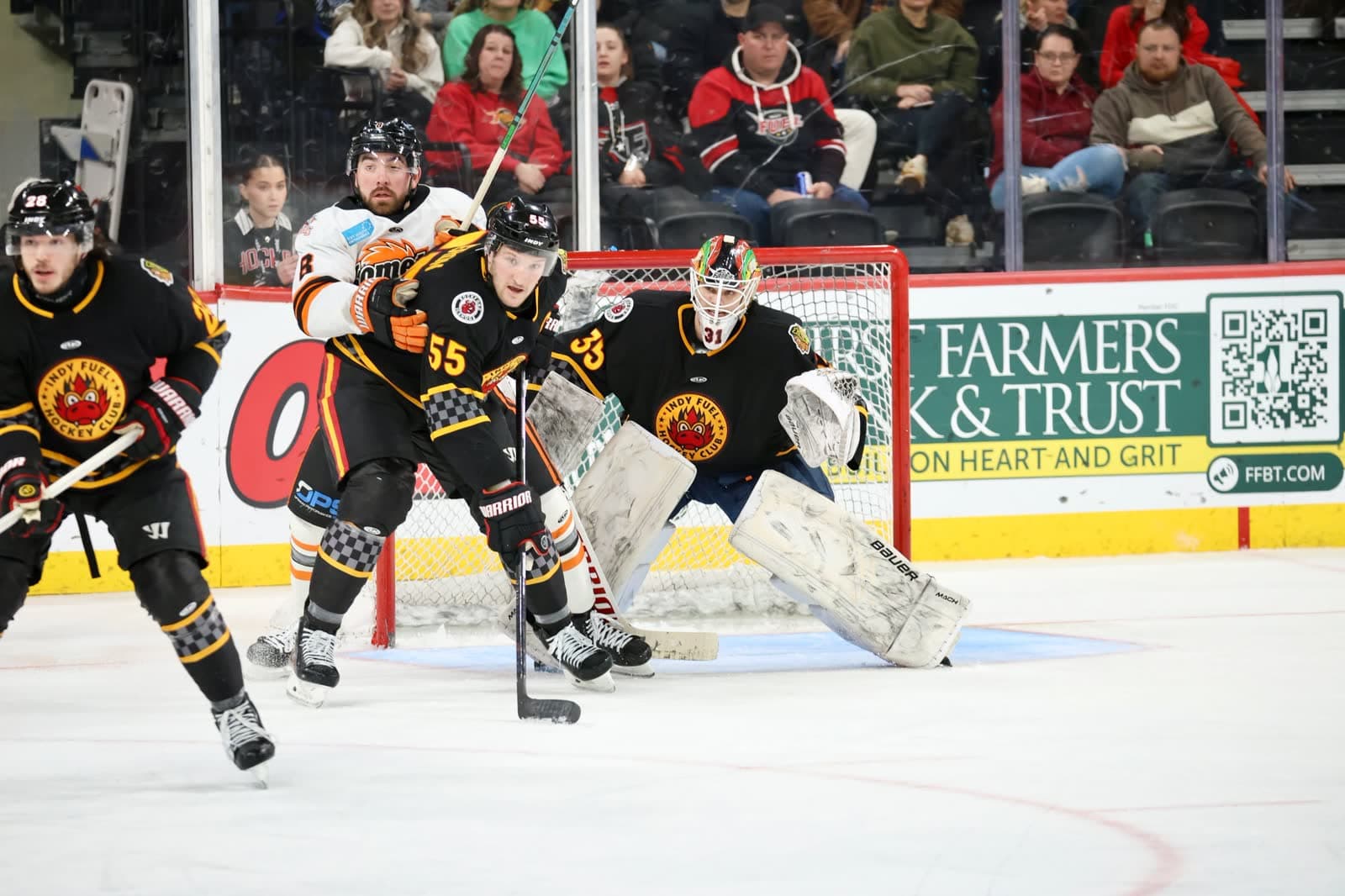 A goalie set in traffic, alone in the crease.