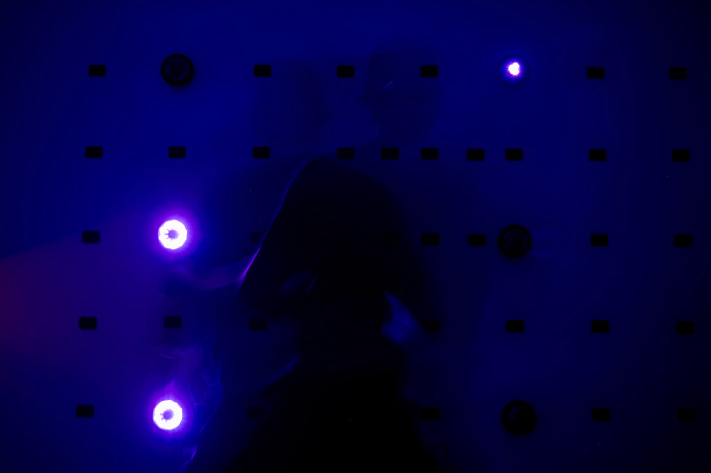 A goalie training against lit targets in the dark at AESV