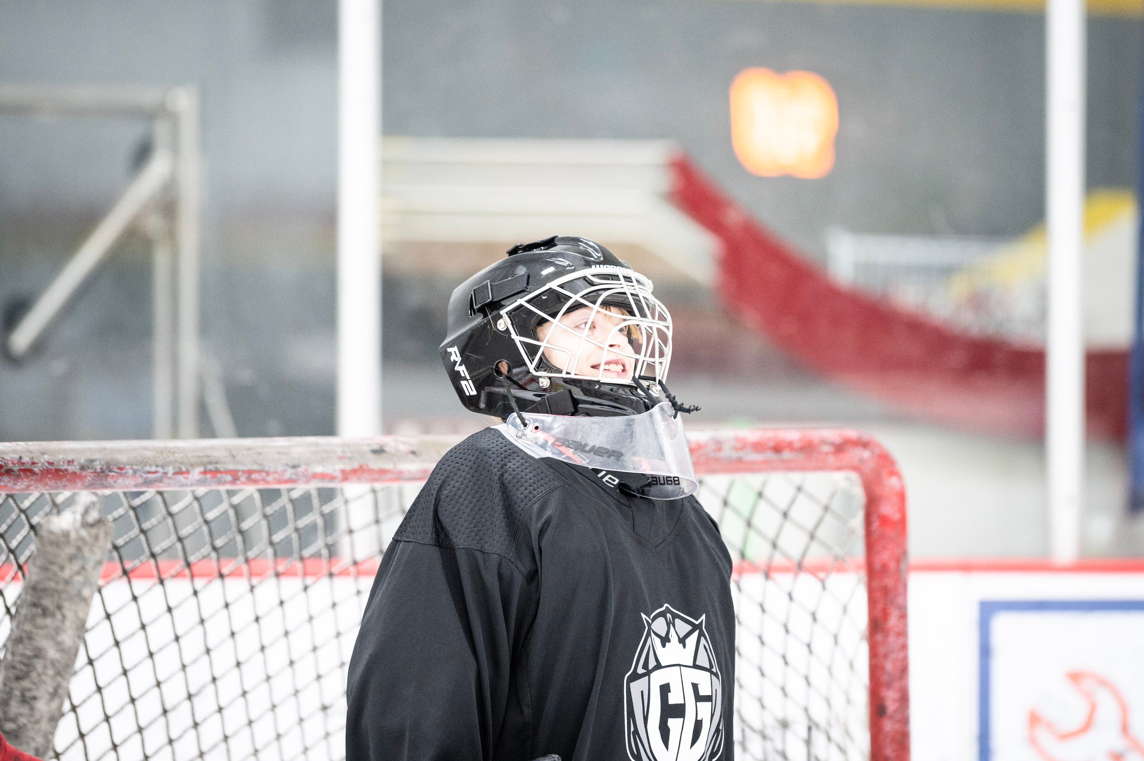 Young CGG goalie smiling through their cage