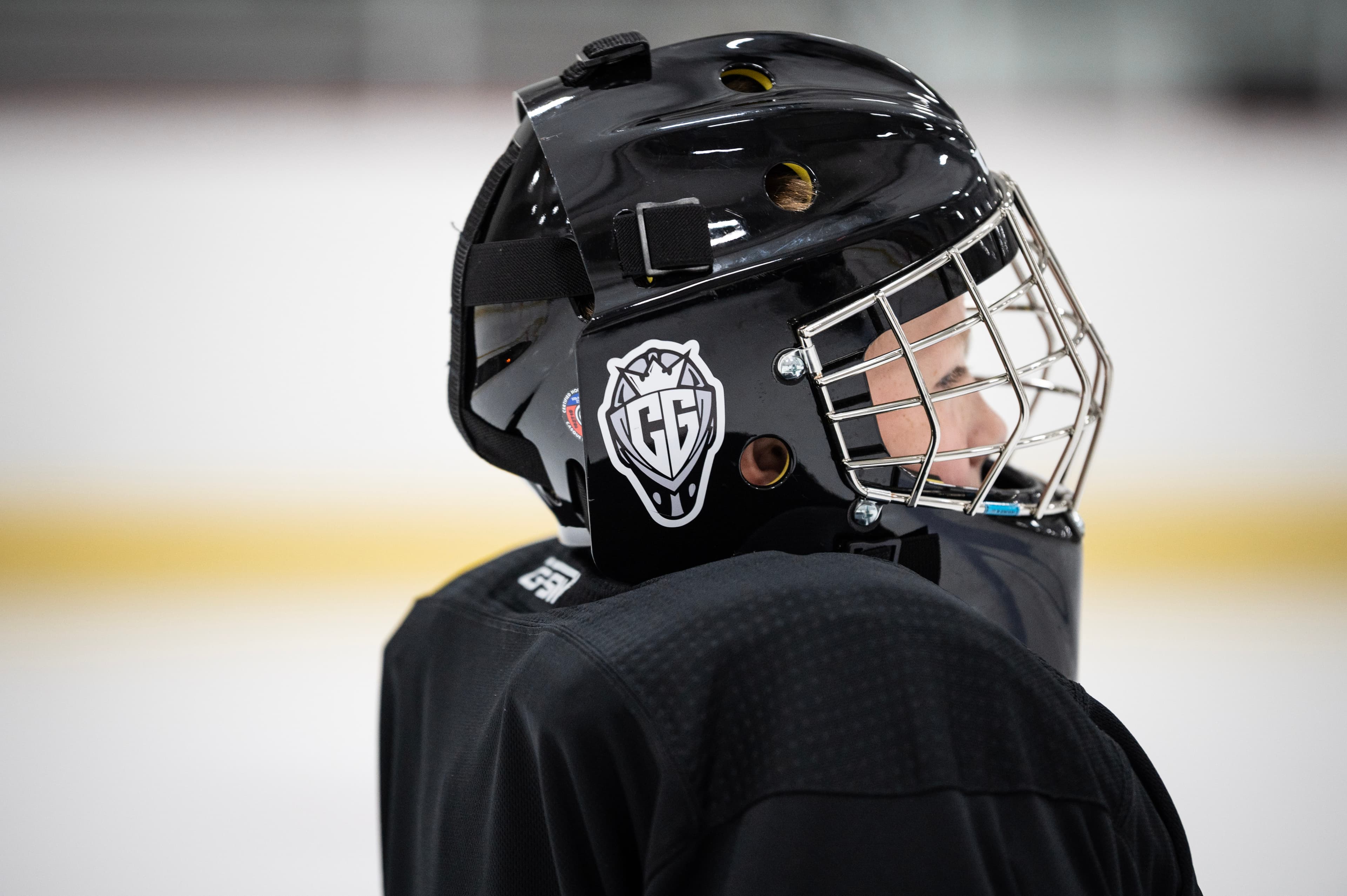 A CGG goalie in their helmet, looking out over the ice.