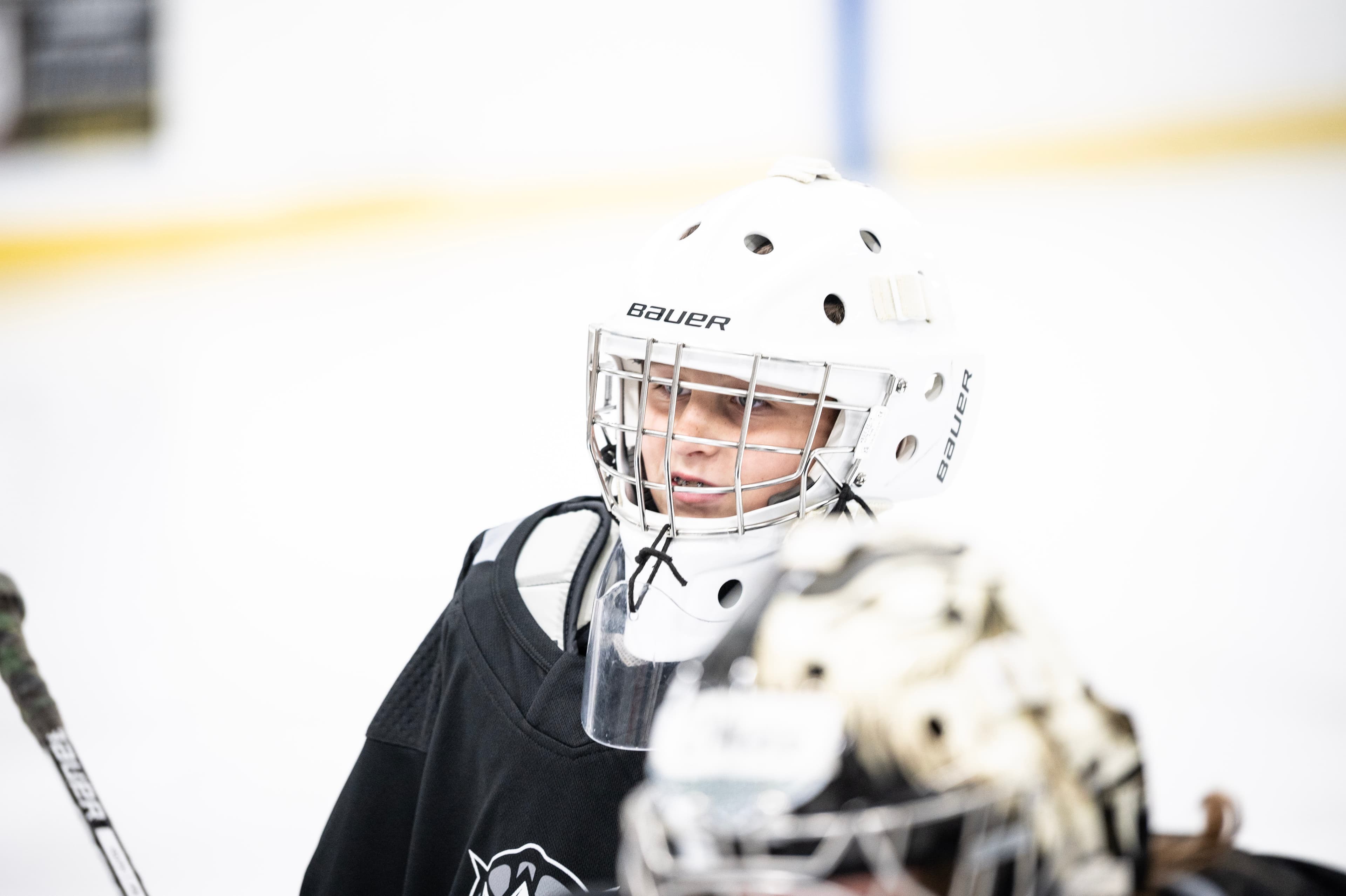 A young CGG goalie in their mask, waiting on the next rep.