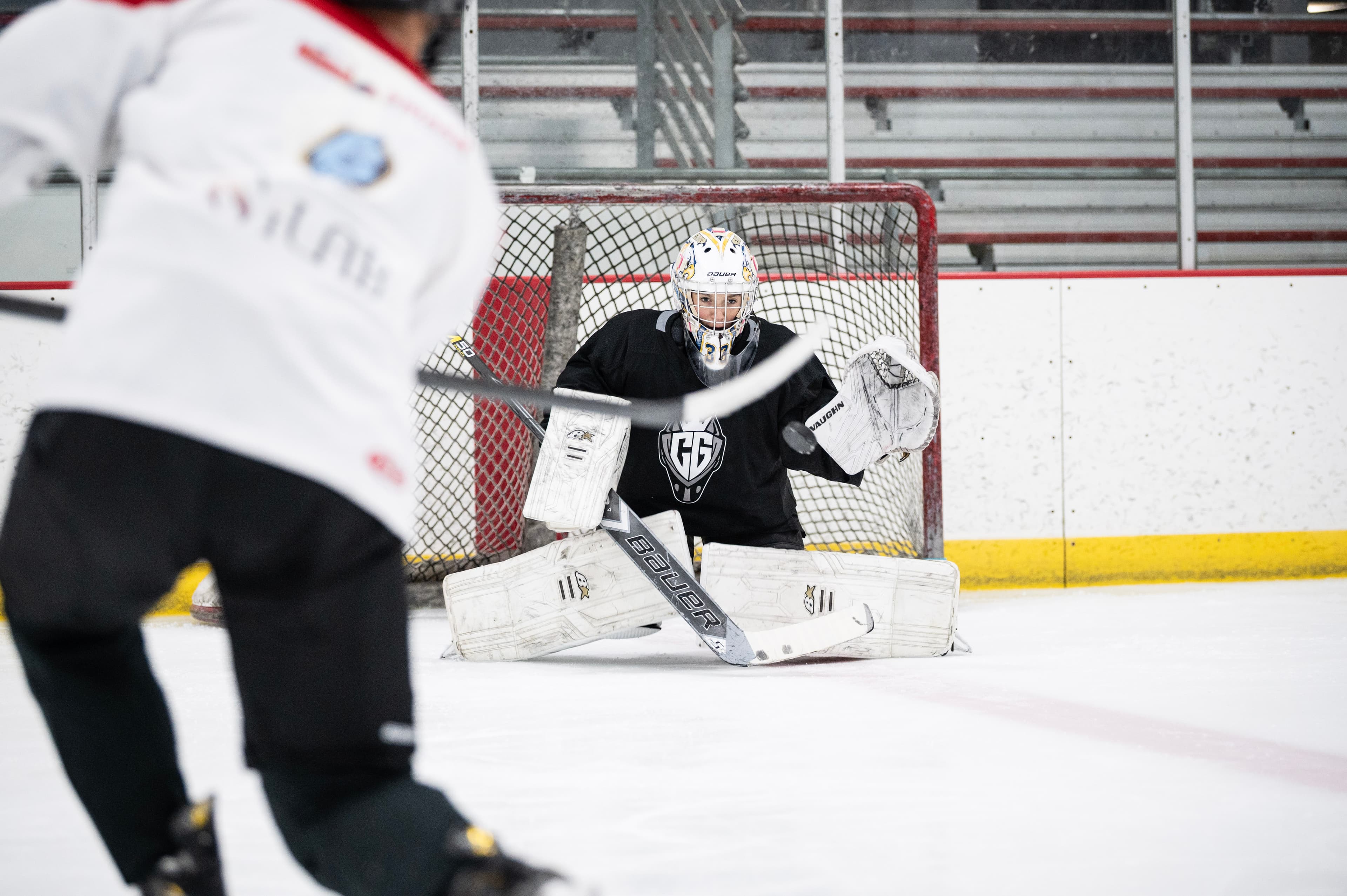 CGG goaltender set in the net facing a shooter