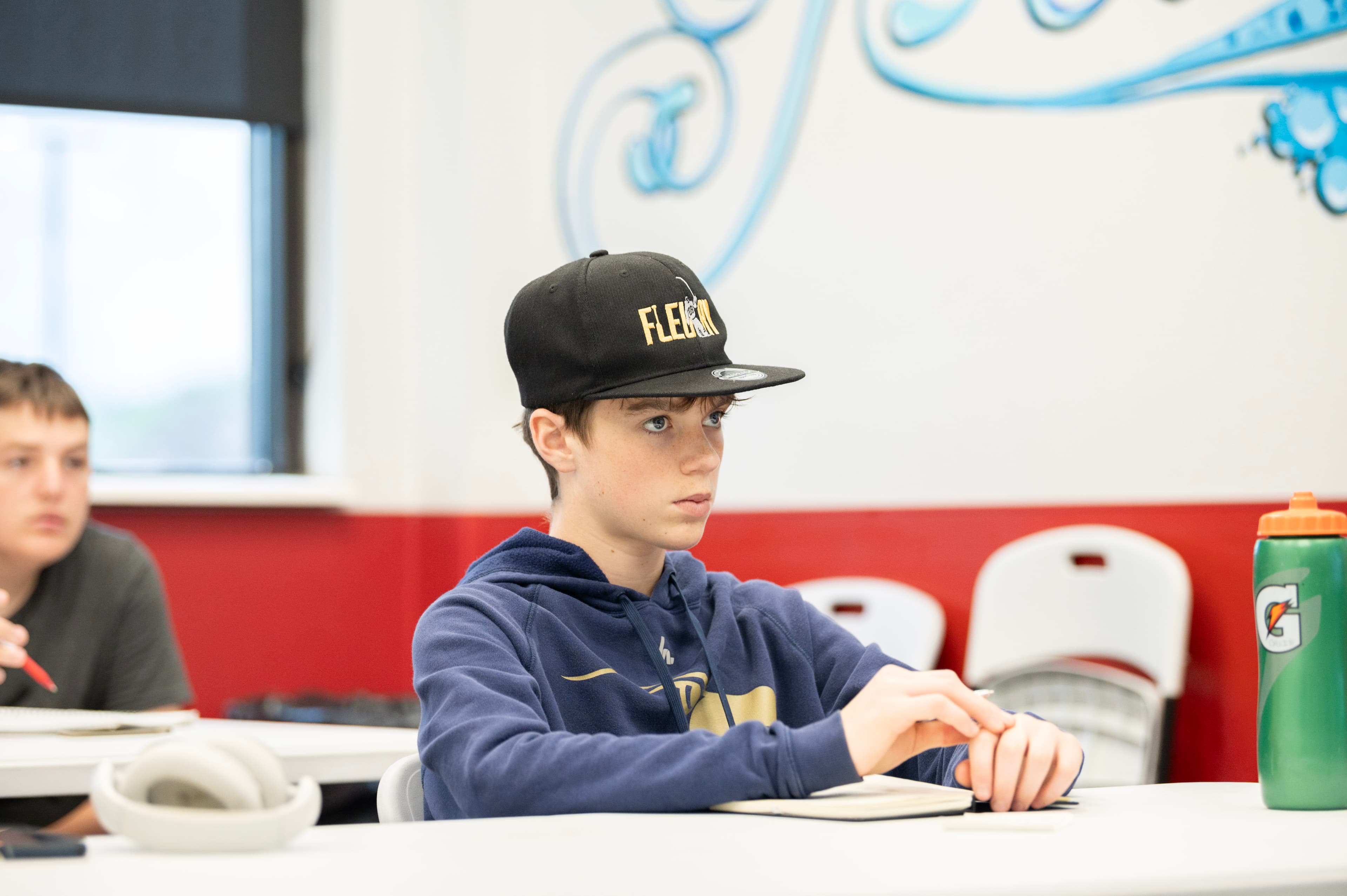 A goalie studying at a table during a CGG session.