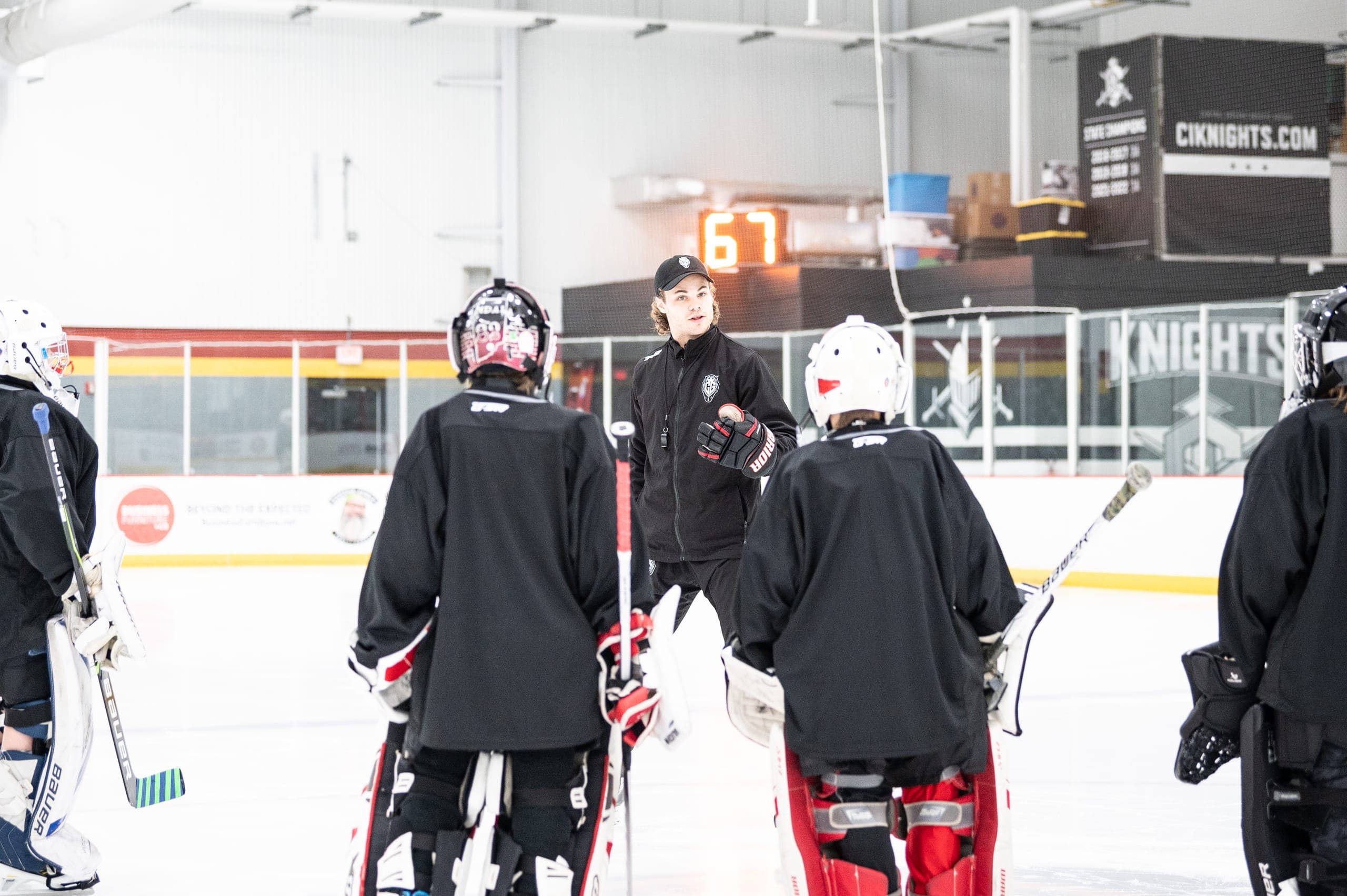 Cam Gray on the ice with a group of CGG goalies during a camp session.
